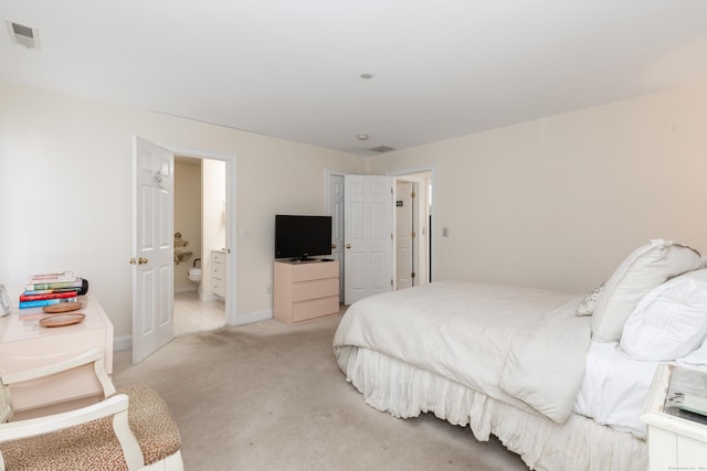 bedroom with light carpet, baseboards, visible vents, and connected bathroom