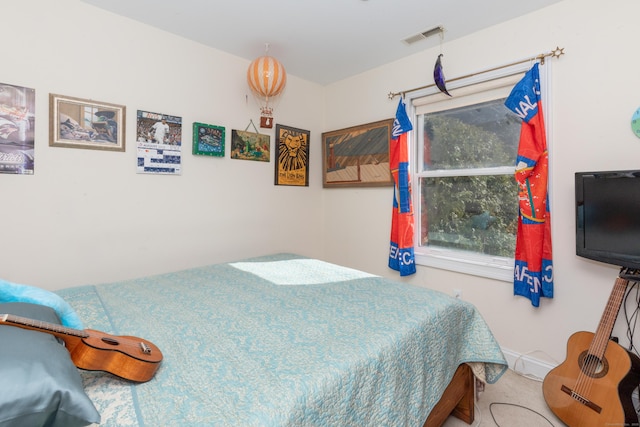 bedroom with visible vents and multiple windows