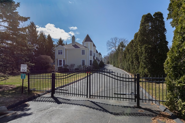 view of gate featuring fence and a yard