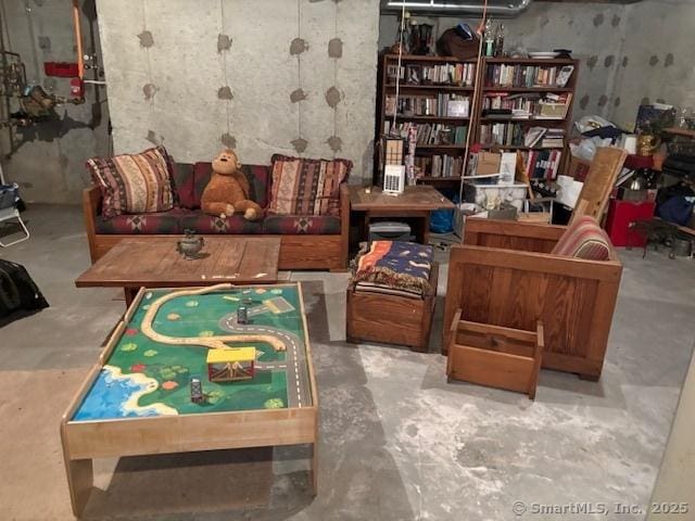 sitting room with unfinished concrete flooring