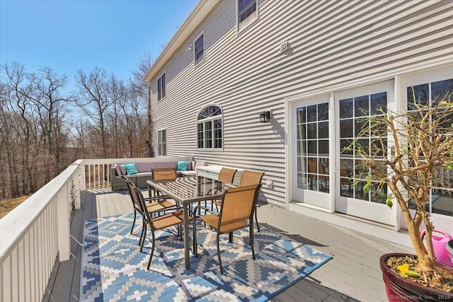 deck featuring outdoor dining space and an outdoor living space