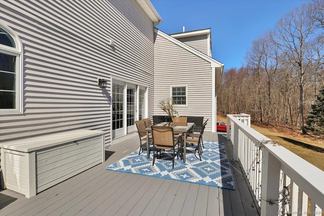 wooden terrace featuring outdoor dining space