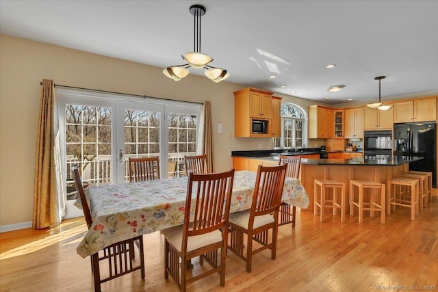 dining space with recessed lighting, french doors, baseboards, and light wood-style flooring