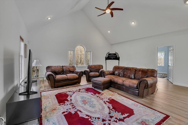 living room featuring ceiling fan, high vaulted ceiling, and wood finished floors