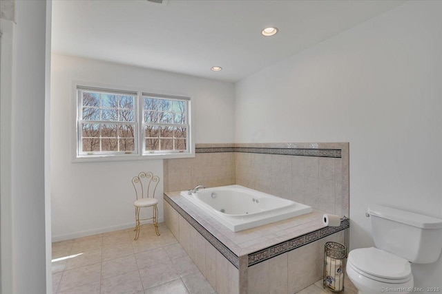 bathroom featuring baseboards, recessed lighting, tile patterned flooring, a garden tub, and toilet