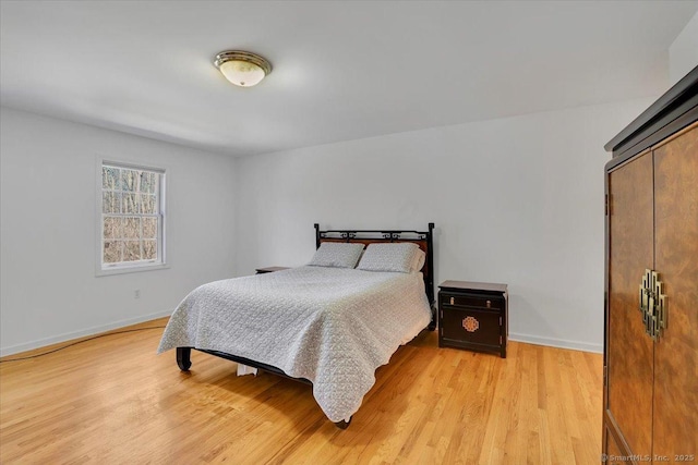 bedroom featuring baseboards and light wood-type flooring