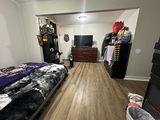 bedroom featuring baseboards and wood finished floors