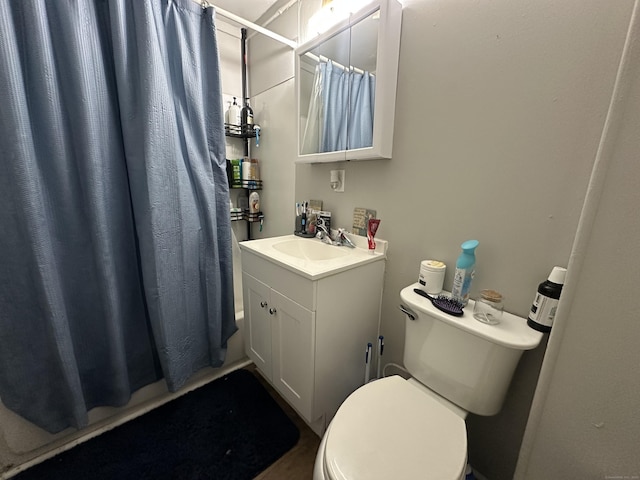 bathroom featuring a shower with curtain, toilet, and vanity