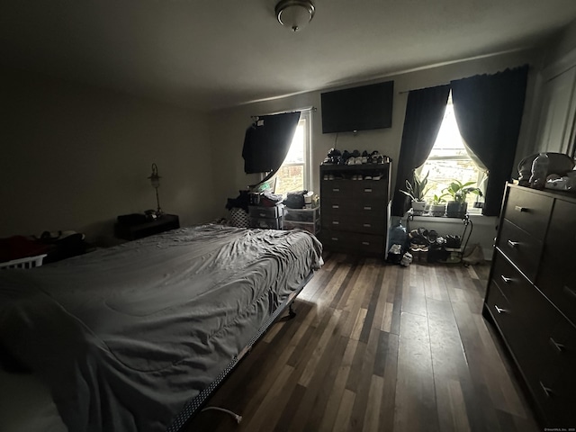 bedroom with dark wood-type flooring