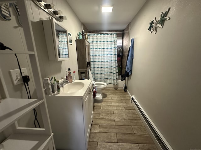 bathroom with baseboards, toilet, baseboard heating, vanity, and wood tiled floor