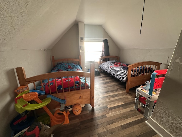 bedroom featuring lofted ceiling and hardwood / wood-style flooring