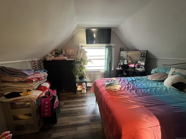 bedroom featuring hardwood / wood-style floors and vaulted ceiling