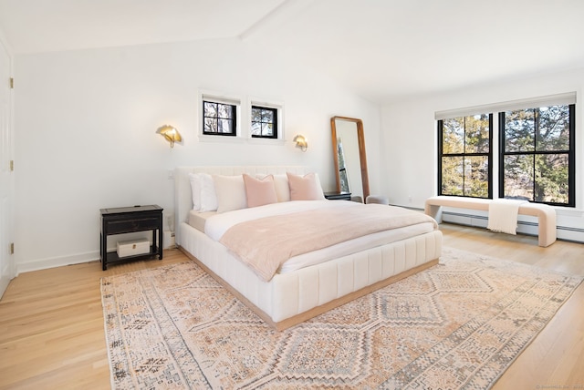 bedroom with multiple windows, vaulted ceiling with beams, and light wood finished floors