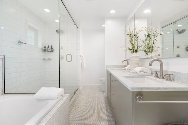 bathroom featuring a shower stall, toilet, a garden tub, and a sink