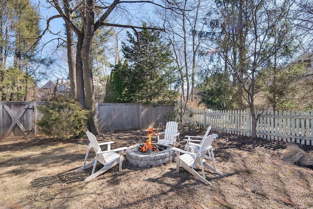 view of yard featuring an outdoor fire pit and a fenced backyard