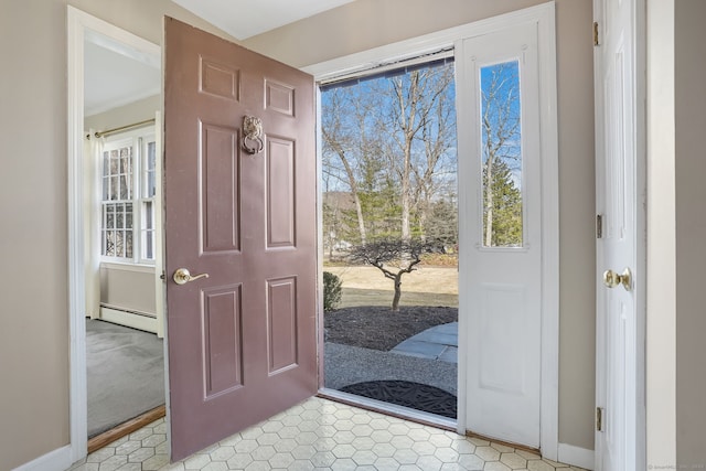 foyer entrance with a healthy amount of sunlight, baseboards, and baseboard heating