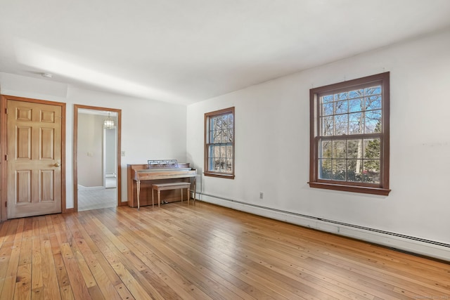 interior space featuring a baseboard radiator and light wood finished floors