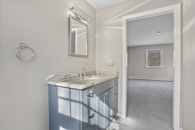 bathroom featuring a baseboard radiator, baseboards, and vanity