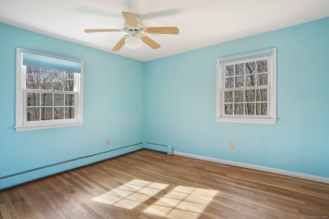 unfurnished room with ceiling fan, wood finished floors, baseboards, and a baseboard radiator