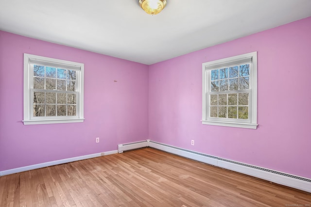 unfurnished room with light wood-style flooring, baseboards, and baseboard heating