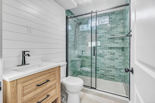 full bathroom with vanity, toilet, and a stall shower