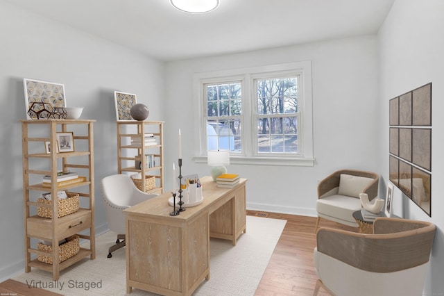 office featuring visible vents, baseboards, and light wood-style floors