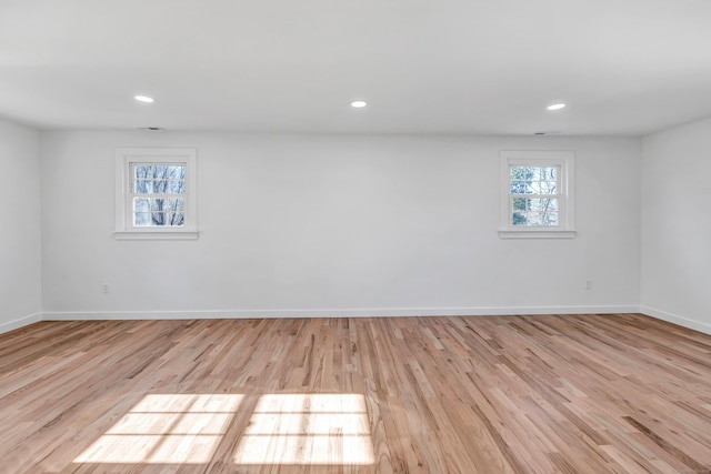 unfurnished room featuring recessed lighting, baseboards, and wood finished floors