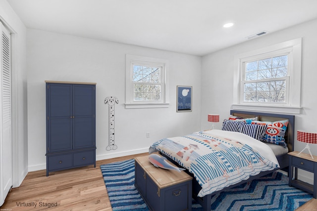 bedroom featuring recessed lighting, visible vents, baseboards, and light wood finished floors