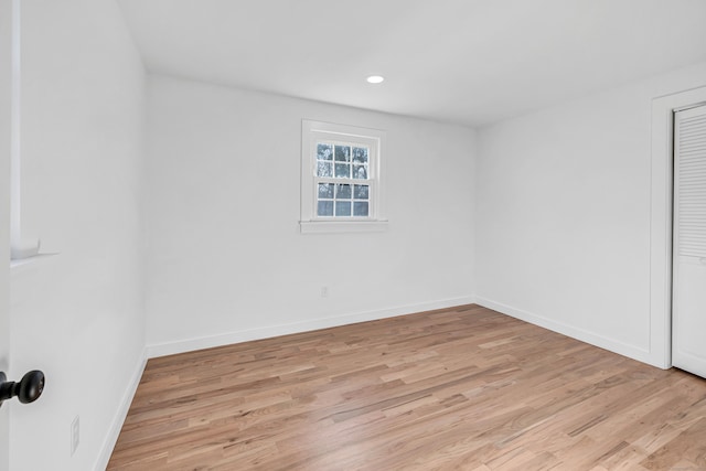 empty room featuring recessed lighting, light wood-style floors, and baseboards