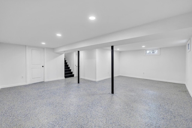 basement with stairs, recessed lighting, and baseboards