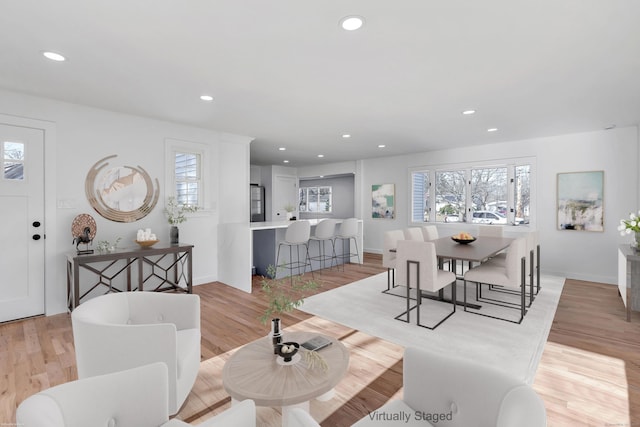 dining space with recessed lighting, light wood-style floors, and baseboards