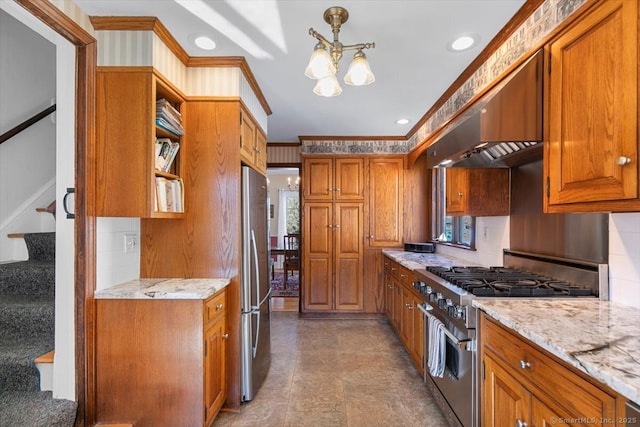 kitchen featuring under cabinet range hood, brown cabinetry, appliances with stainless steel finishes, and a healthy amount of sunlight