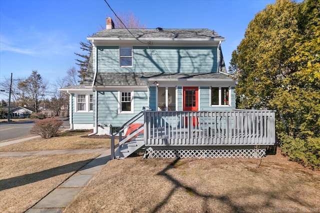 view of front of home with roof with shingles and a chimney