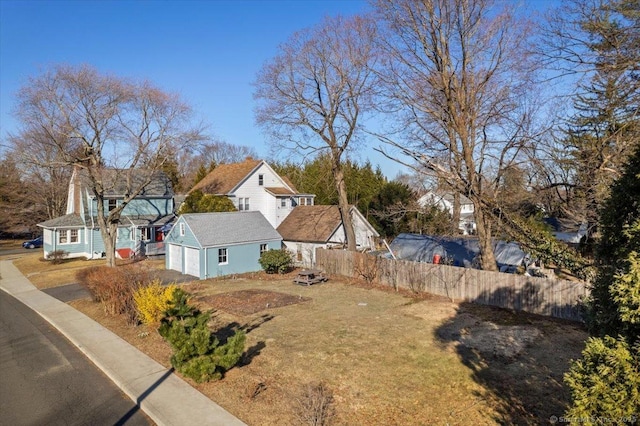 view of yard featuring an outbuilding and fence