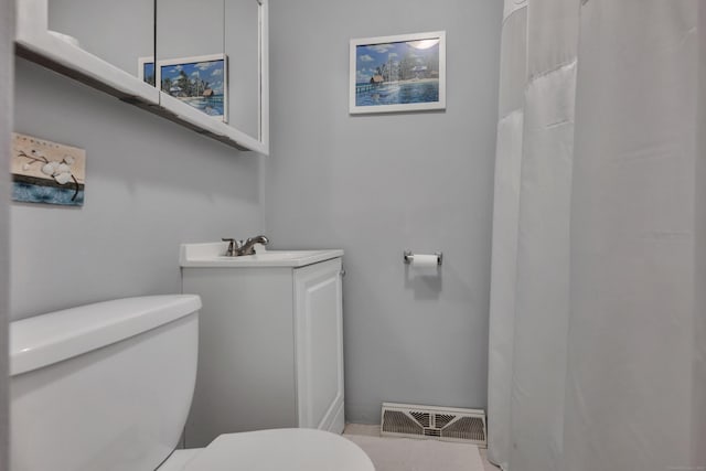 bathroom featuring visible vents, toilet, and vanity