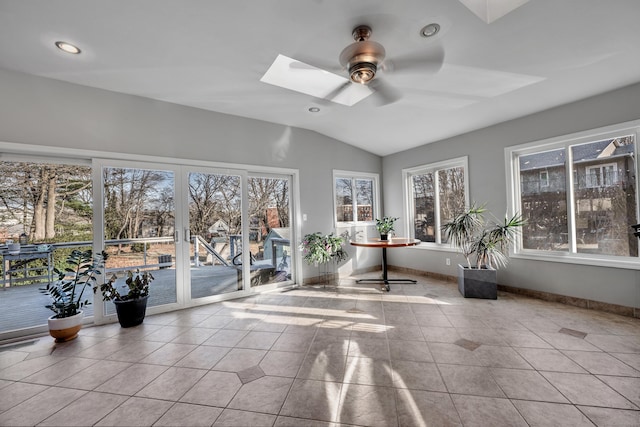 unfurnished sunroom featuring vaulted ceiling with skylight and ceiling fan