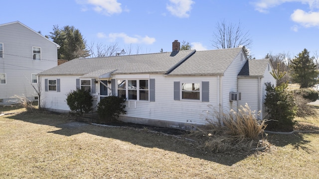 exterior space with a lawn, a chimney, and roof with shingles