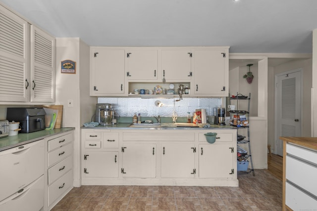 kitchen featuring open shelves, a sink, light countertops, white cabinets, and tasteful backsplash