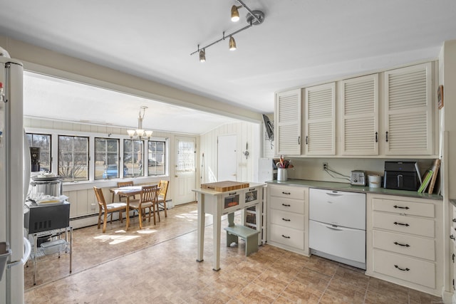 kitchen featuring a chandelier, freestanding refrigerator, and a baseboard radiator