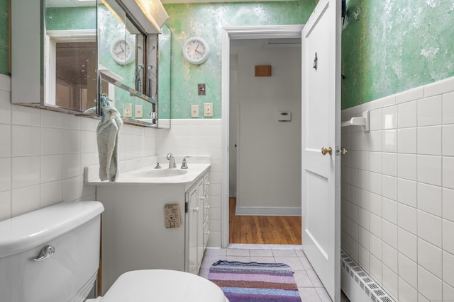 bathroom featuring a wainscoted wall, toilet, wallpapered walls, tile patterned flooring, and vanity