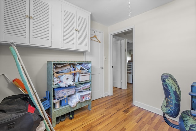 office space featuring baseboards and light wood-style floors