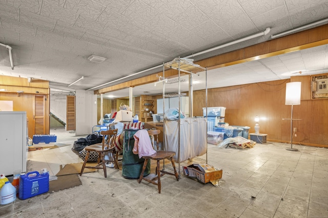 finished basement featuring tile patterned floors and wooden walls