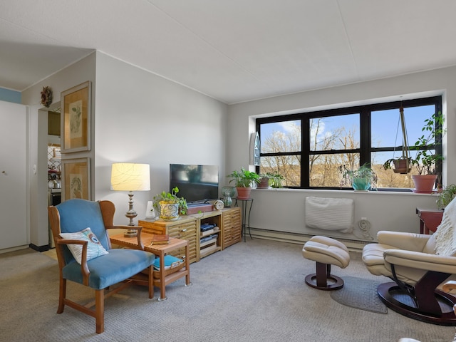 living room featuring baseboard heating, a healthy amount of sunlight, and carpet floors