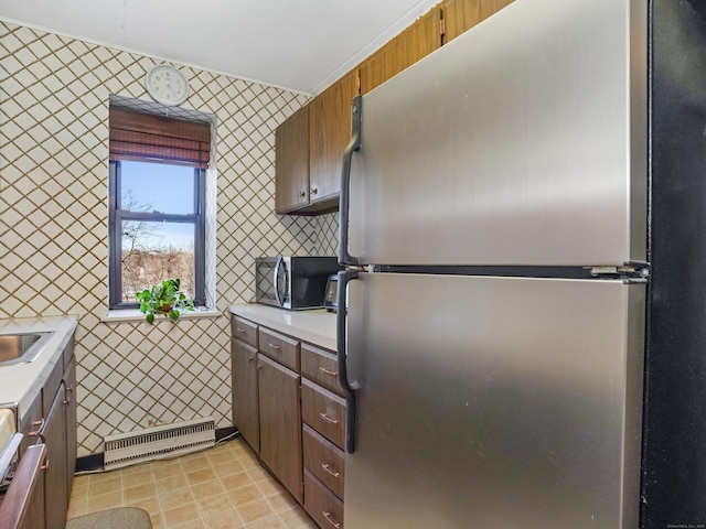 kitchen with light tile patterned floors, visible vents, stainless steel appliances, light countertops, and tile walls