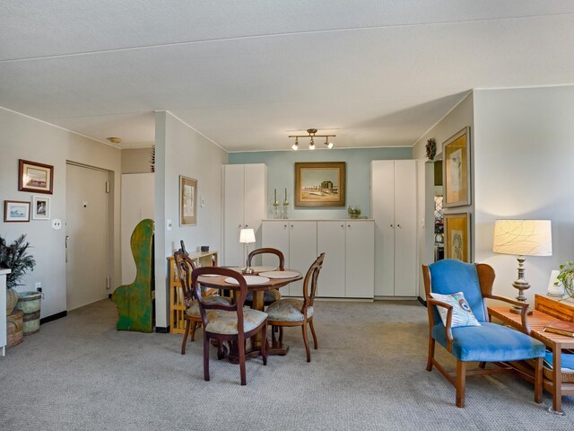 dining area featuring light carpet