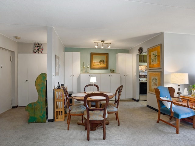 dining area with light colored carpet