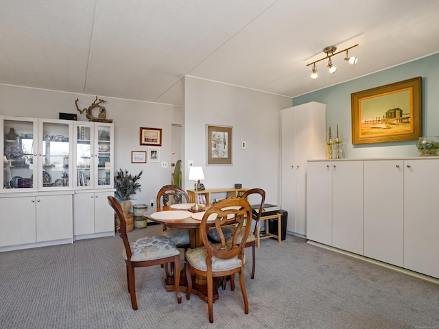 dining room featuring light carpet