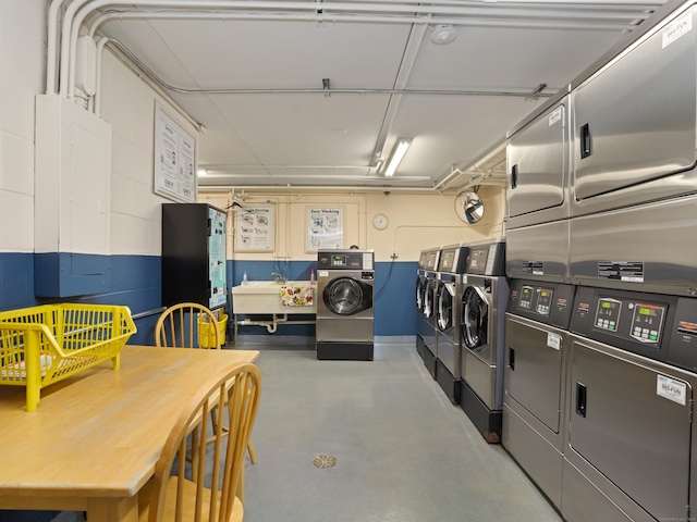 shared laundry area featuring washer and dryer, stacked washer / drying machine, and a sink