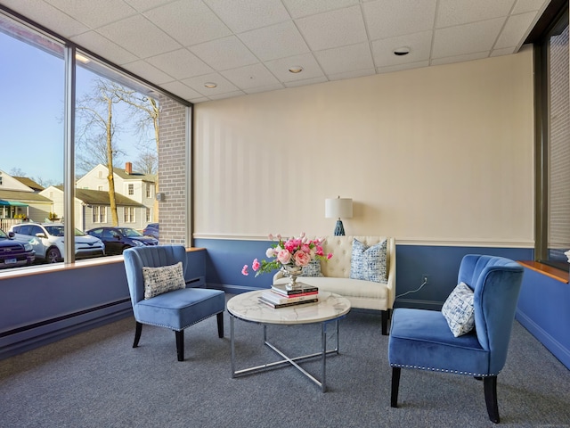 sitting room with a paneled ceiling, baseboards, and carpet floors