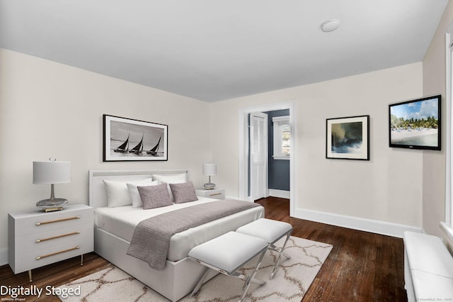 bedroom featuring baseboards and wood finished floors